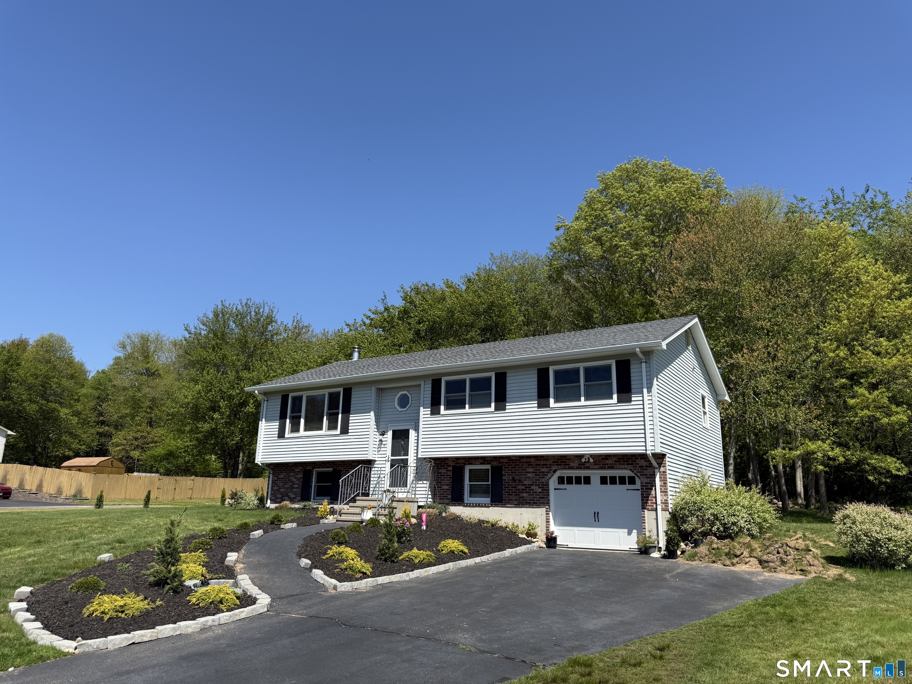 29 Deer Ridge Road Stonington, CT 06378 - Photo 1 of 35 a view of a white house with a swimming pool and a yard