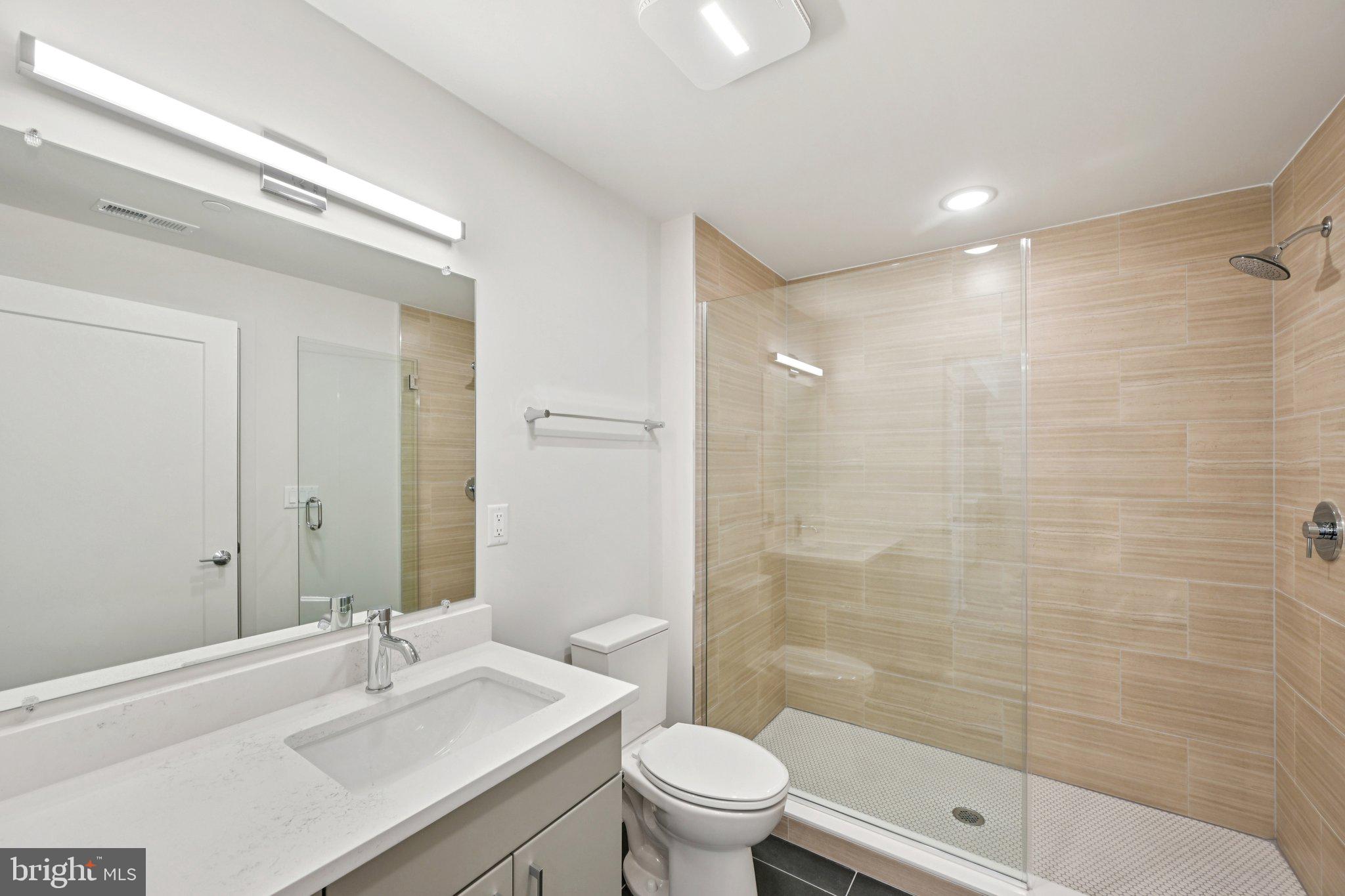 23 Rock Hill Road, Unit 203 Bala Cynwyd, PA 19004 - Photo 5 of 8 a bathroom with a sink a toilet and shower