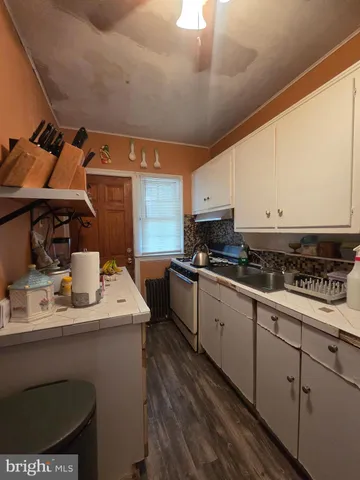 a view of a storage & utility room with refrigerator and washer