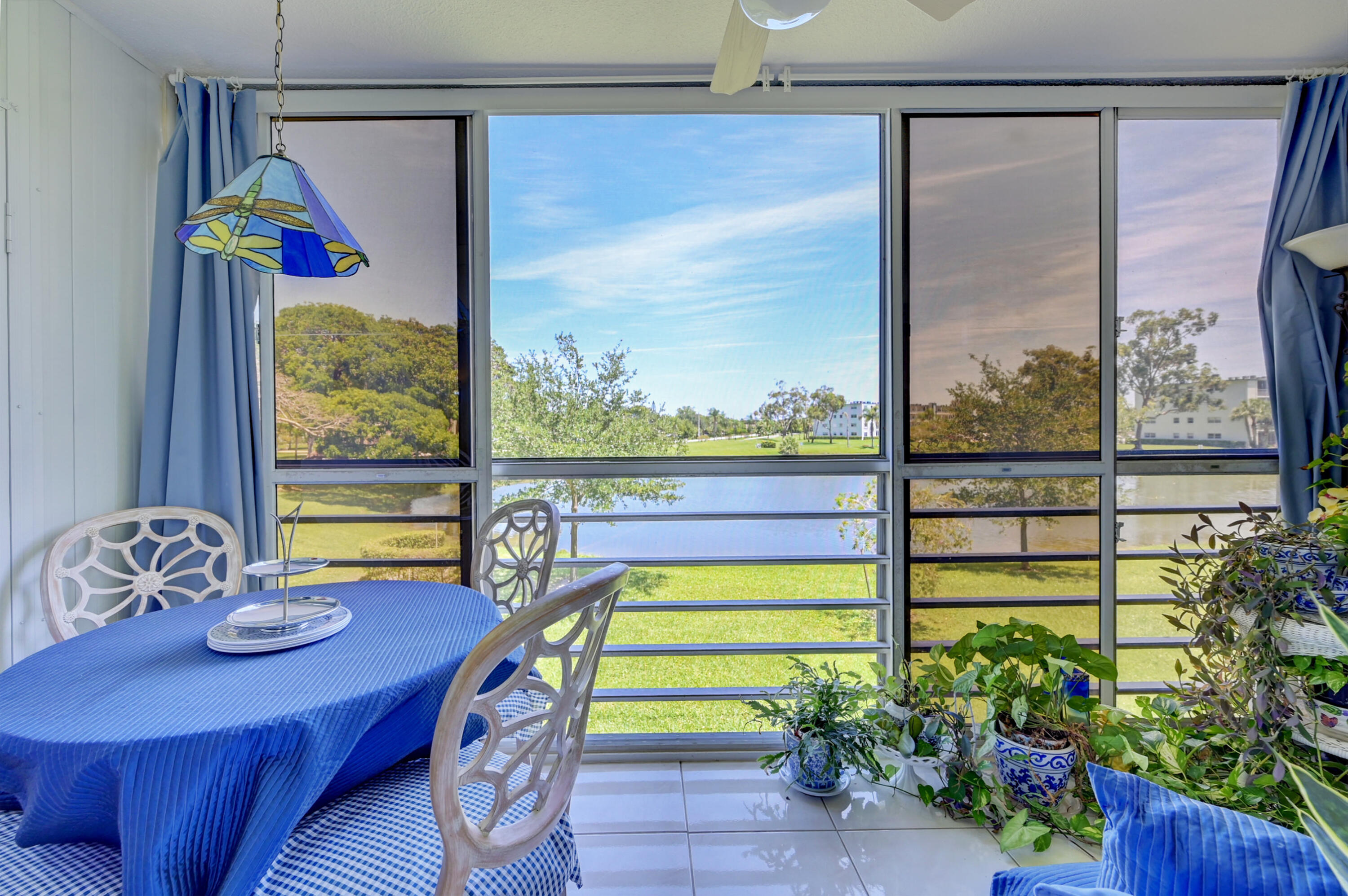 2049 Newcastle A, Unit 2049 Boca Raton, FL 33434 - Photo 1 of 24 a view of a dining room with furniture a chandelier and a window