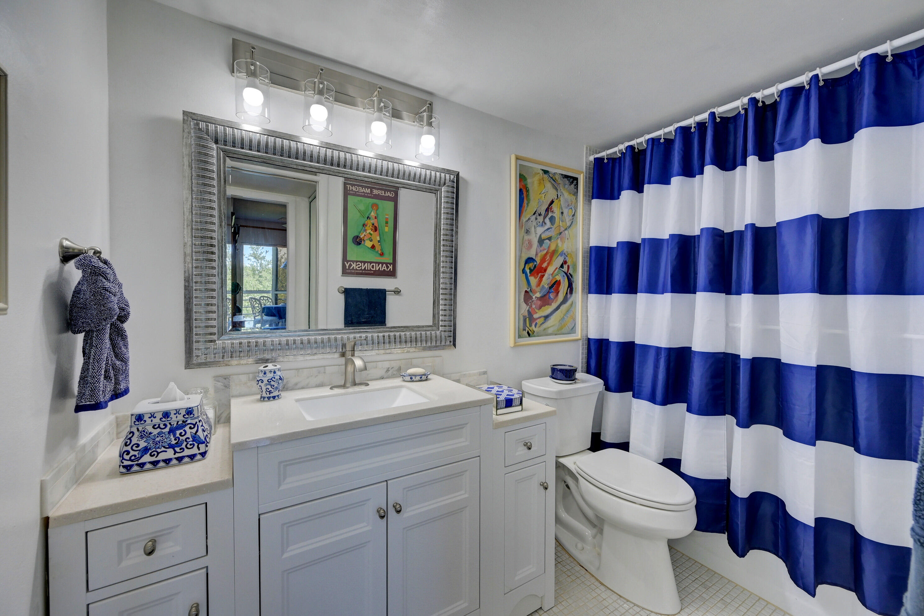 2049 Newcastle A, Unit 2049 Boca Raton, FL 33434 - Photo 13 of 24 a bathroom with a sink a toilet and shower curtain