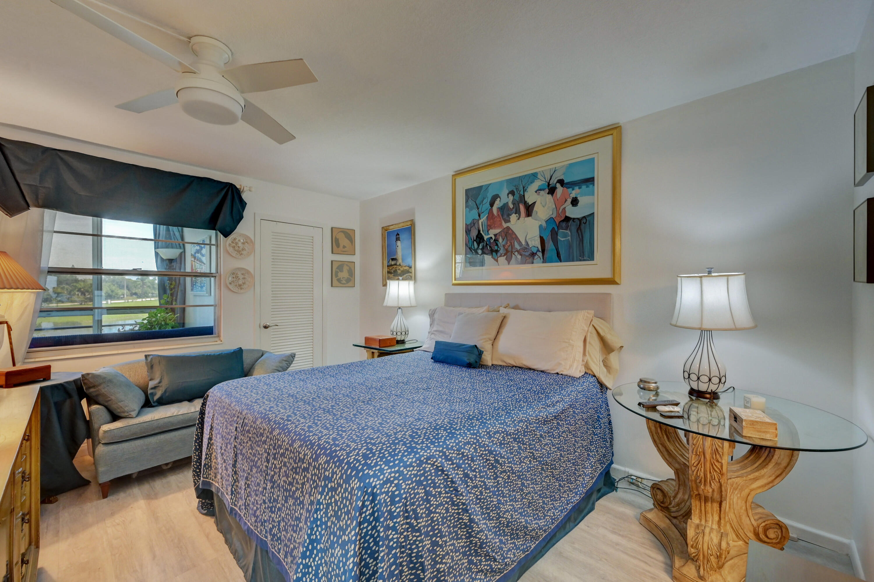 2049 Newcastle A, Unit 2049 Boca Raton, FL 33434 - Photo 14 of 24 a spacious bedroom with a bed a couch and a view of kitchen