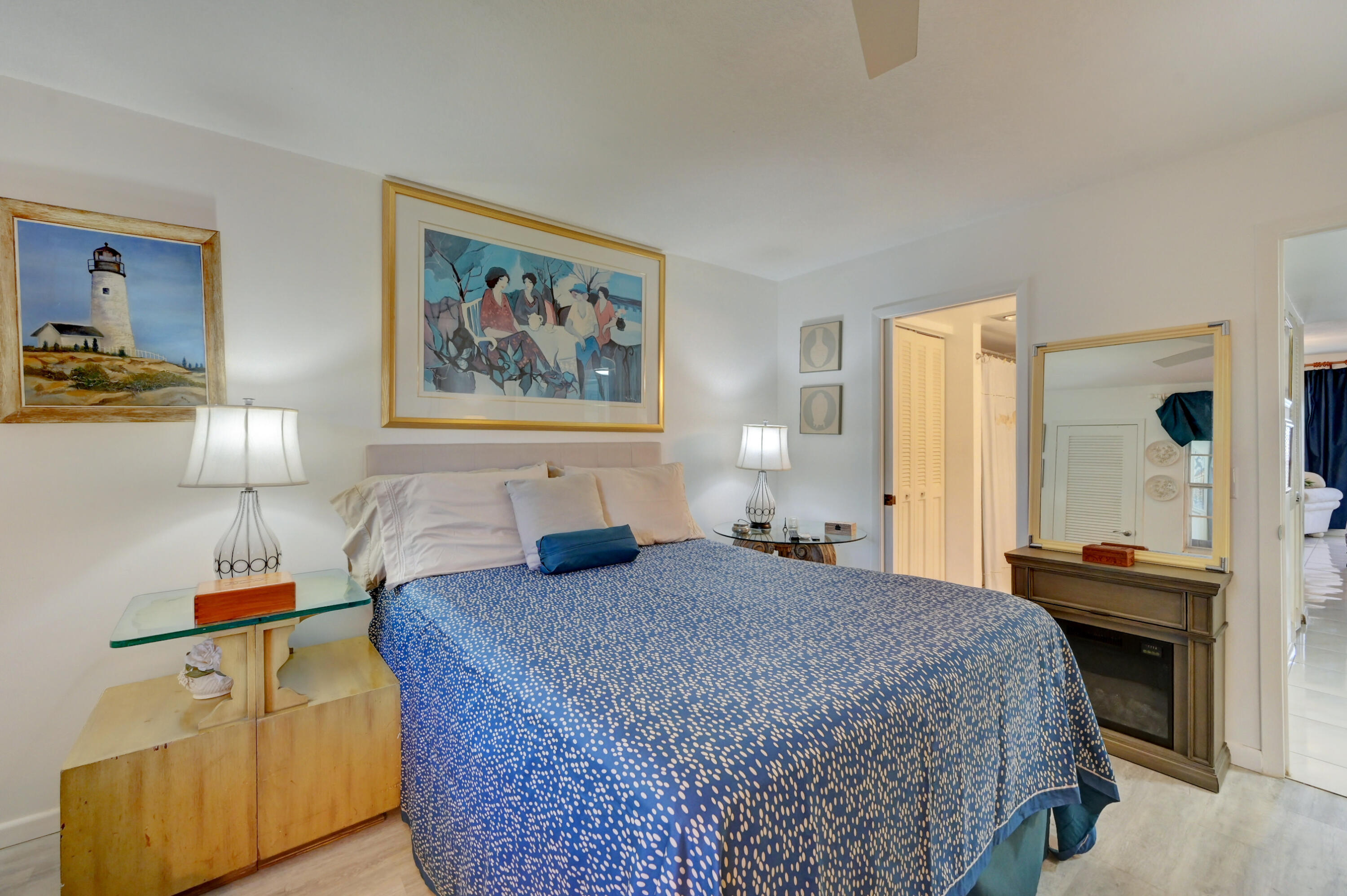 2049 Newcastle A, Unit 2049 Boca Raton, FL 33434 - Photo 16 of 24 a bedroom with a bed and a chandelier