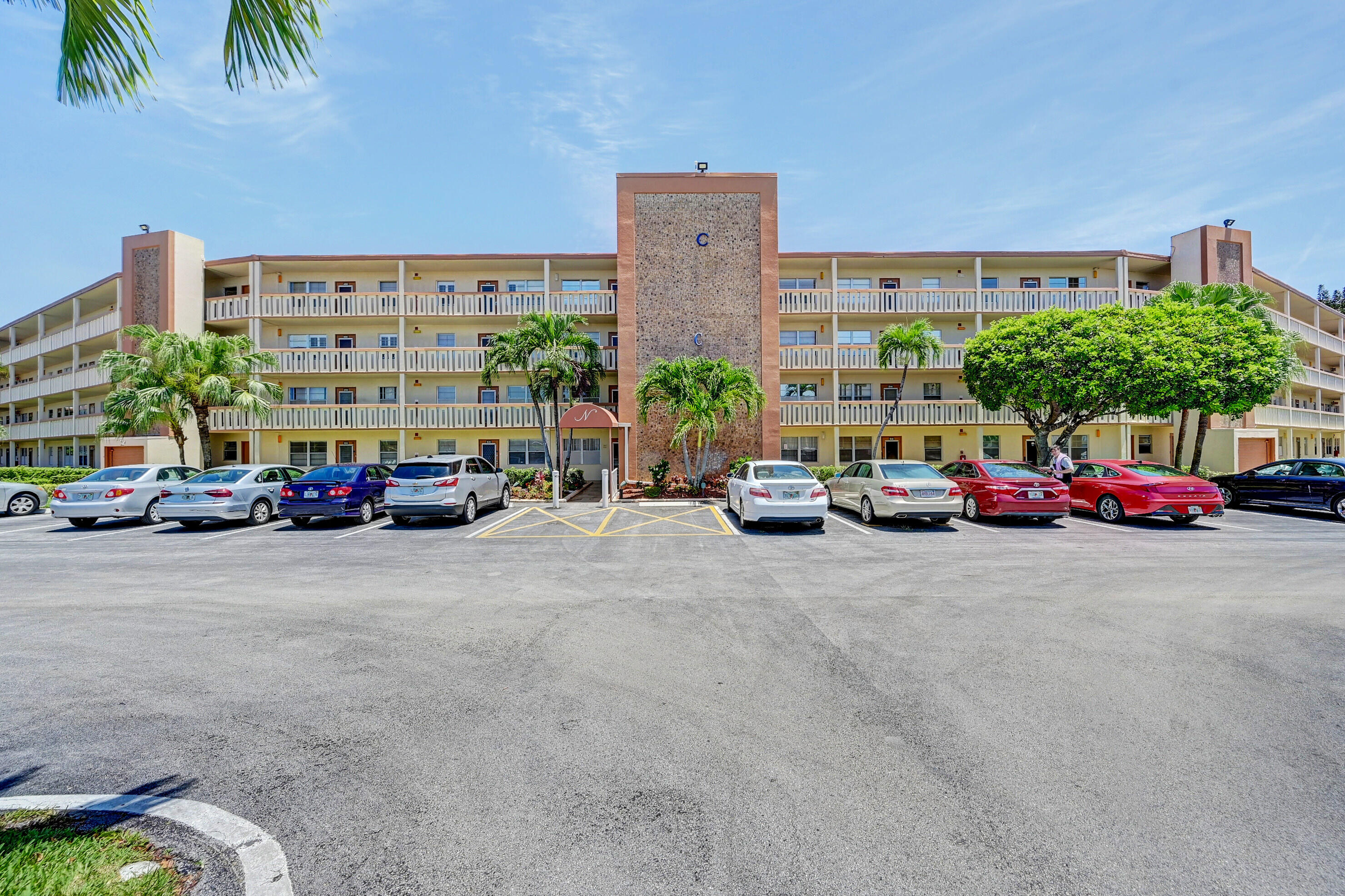 2049 Newcastle A, Unit 2049 Boca Raton, FL 33434 - Photo 23 of 24 a car parked in front of a building