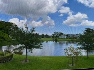 2049 Newcastle A, Unit 2049 Boca Raton, FL 33434 - Photo 4 of 24 a view of a lake with a garden