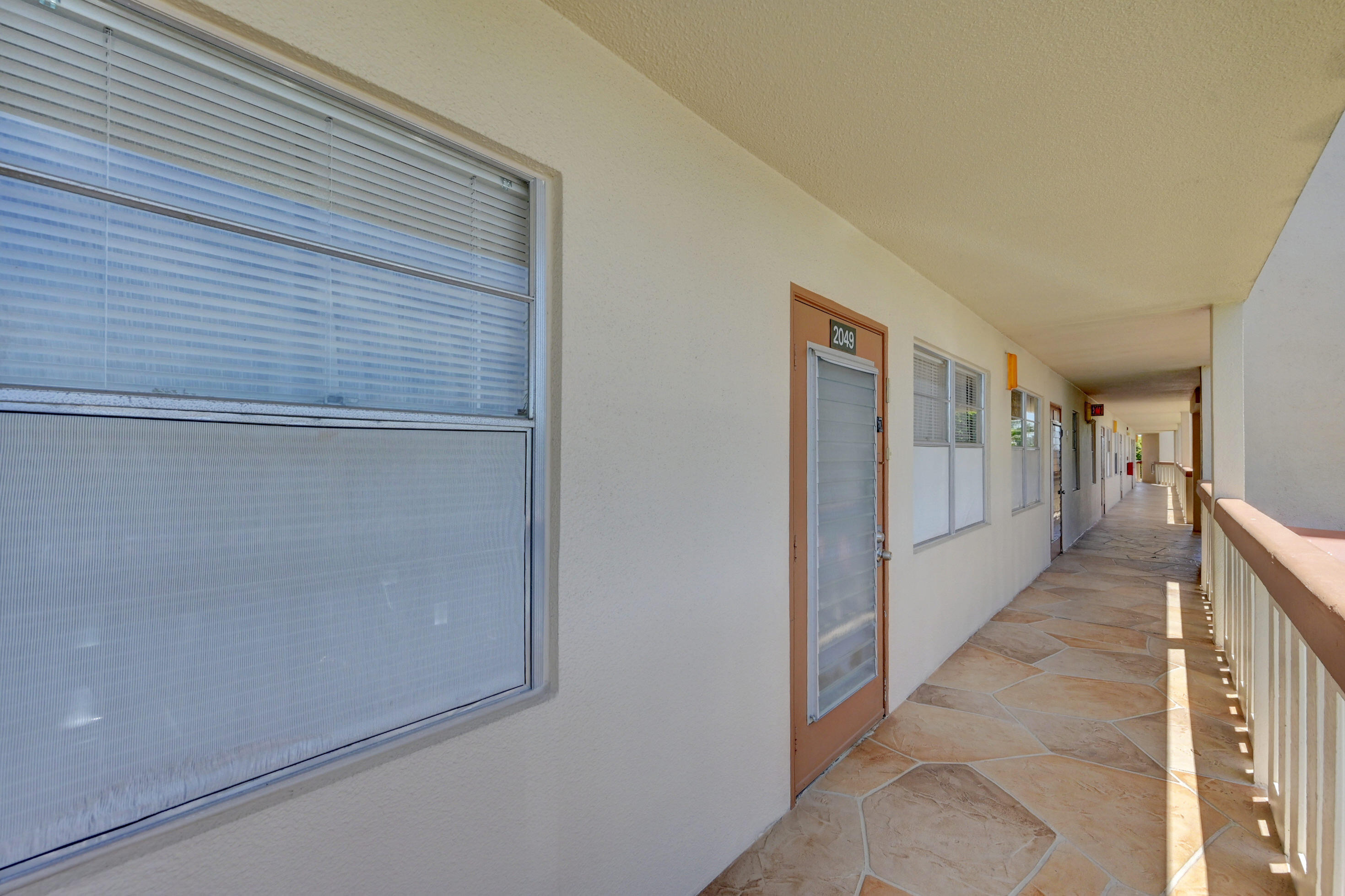 2049 Newcastle A, Unit 2049 Boca Raton, FL 33434 - Photo 5 of 24 a hallway with a large window
