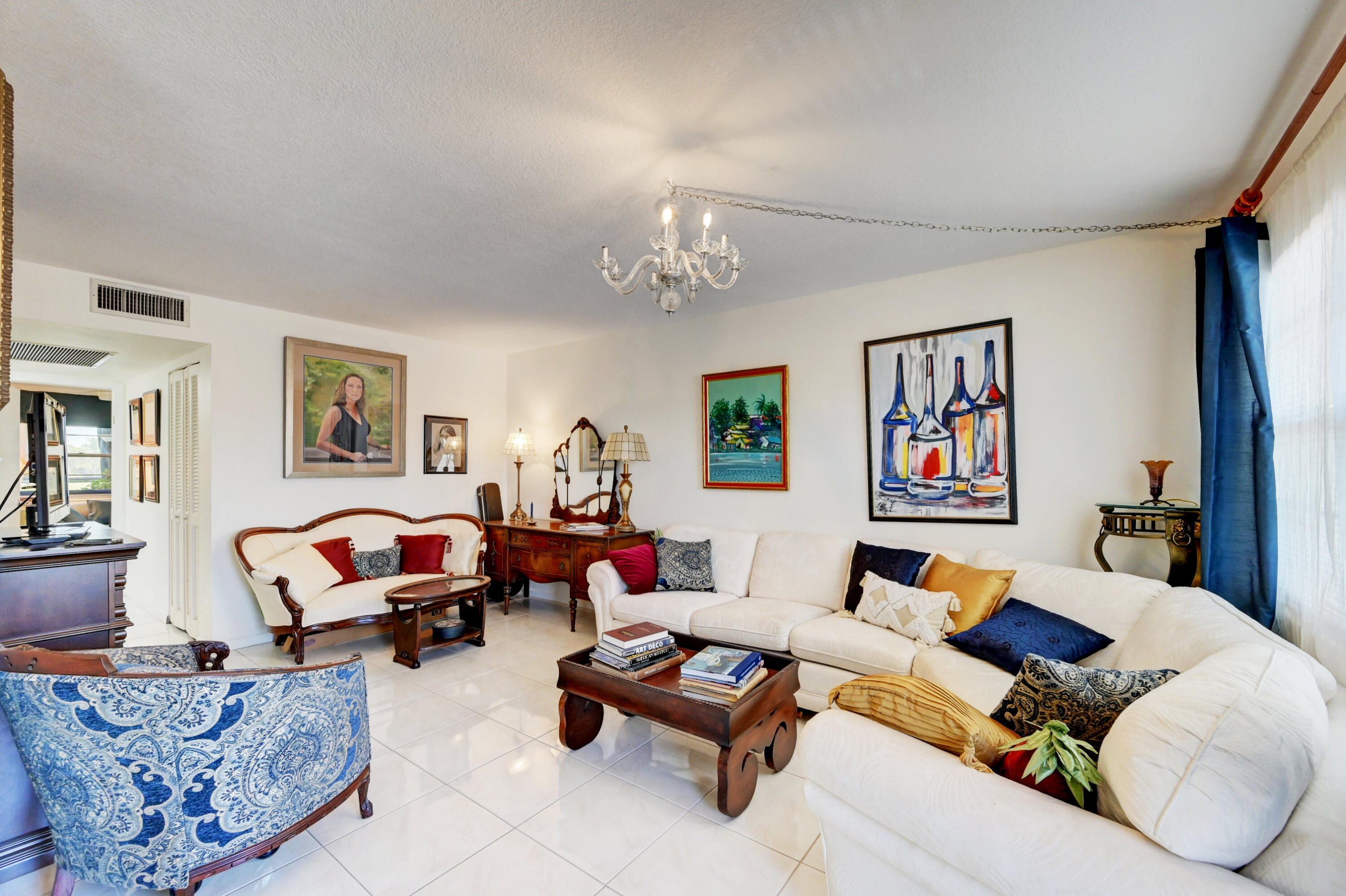 2049 Newcastle A, Unit 2049 Boca Raton, FL 33434 - Photo 7 of 24 a living room with furniture and a chandelier