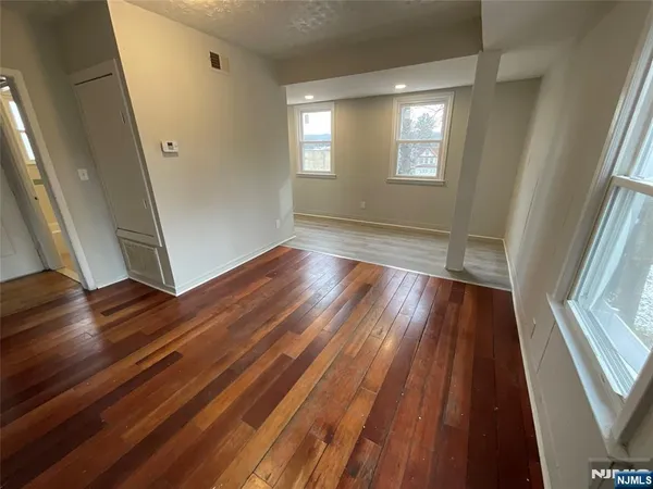wooden floor in an empty room with a window