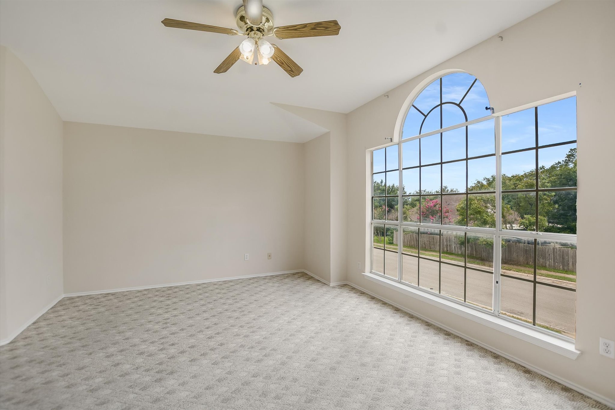 1008 Double File Trail Round Rock, TX 78665 - Photo 12 of 20 A spacious room offers ample natural light and a beautiful view of the neighborhood through its grand arched window.