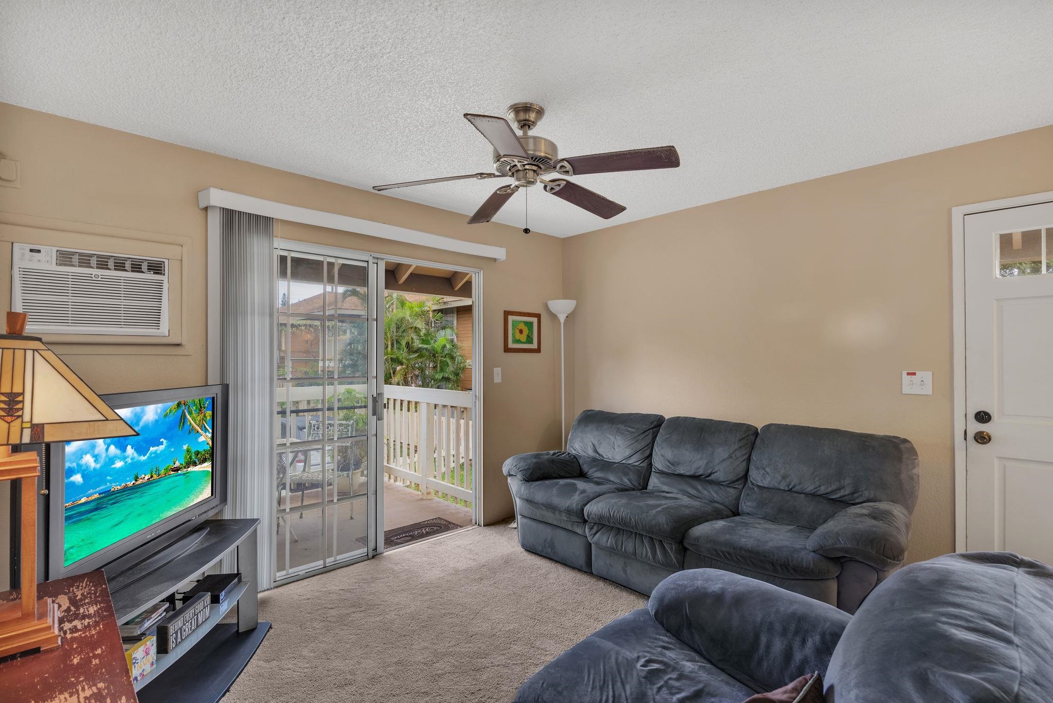 140 Uwapo Road, Unit 9202 Kihei, HI 96753 - Photo 15 of 31 a living room with furniture a flat screen tv and a window