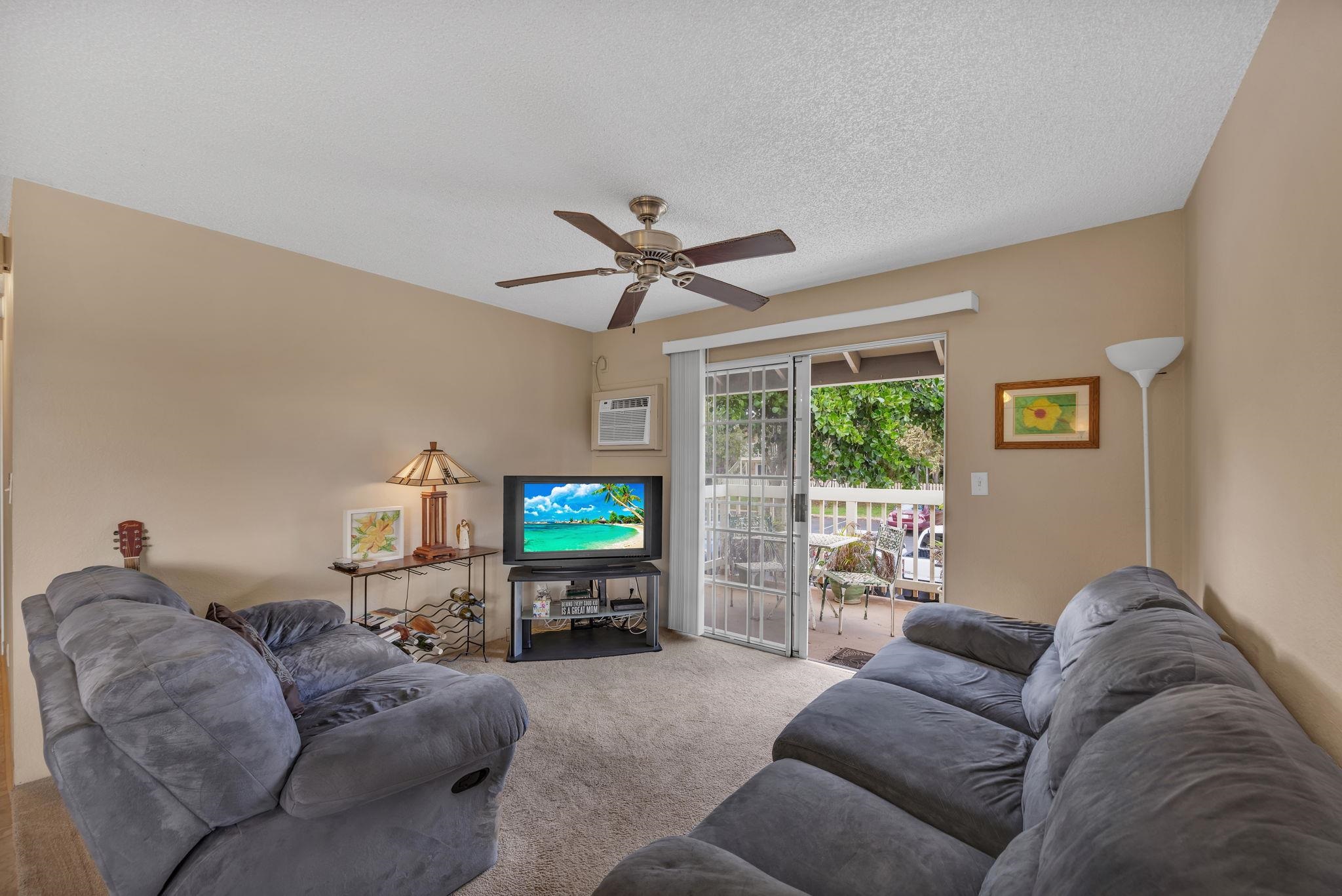 140 Uwapo Road, Unit 9202 Kihei, HI 96753 - Photo 16 of 31 a living room with furniture a floor to ceiling window and a flat screen tv