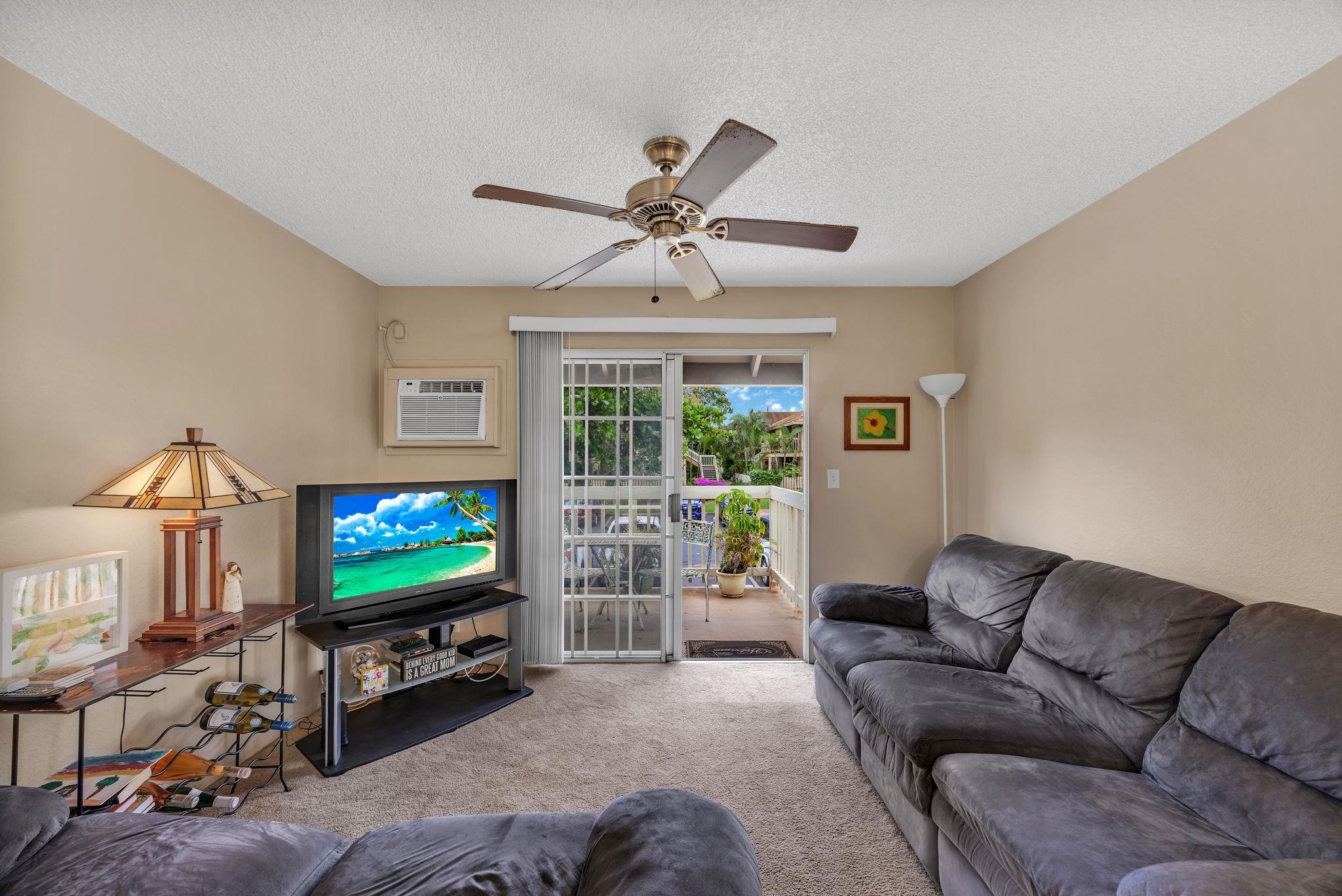 140 Uwapo Road, Unit 9202 Kihei, HI 96753 - Photo 17 of 31 a living room with furniture and a flat screen tv