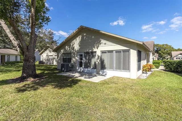 a view of a house with backyard and sitting area