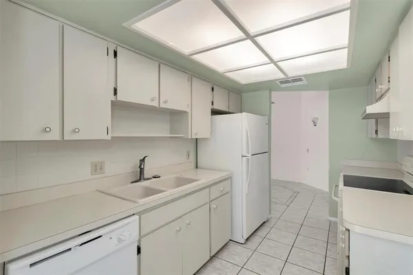 a kitchen with a sink and refrigerator