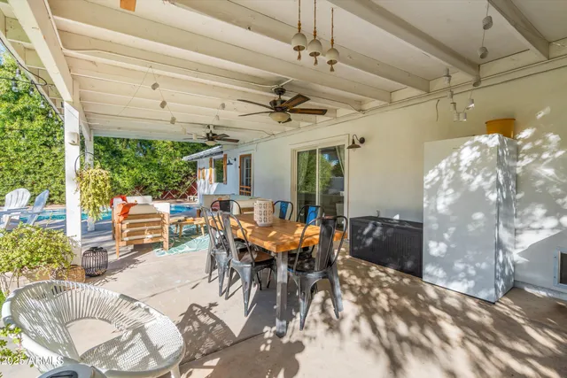 a view of a house with pool and chairs