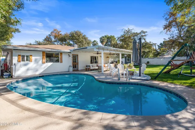 a view of an house with backyard space and balcony