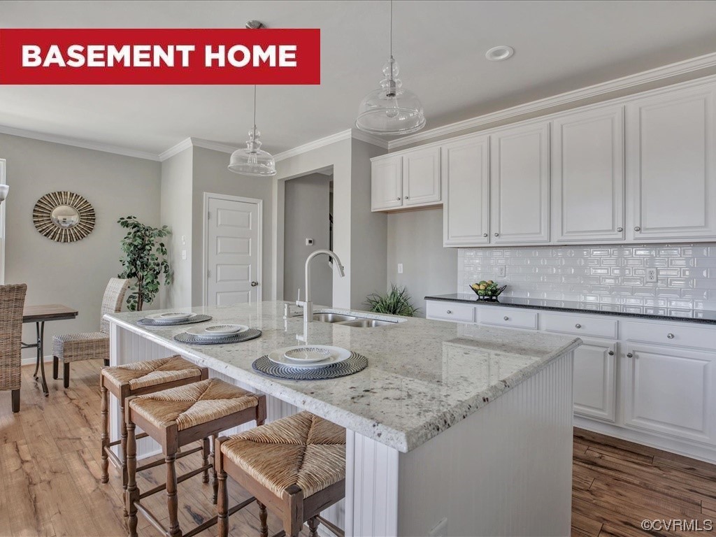 a kitchen with granite countertop a sink white cabinets and white appliances