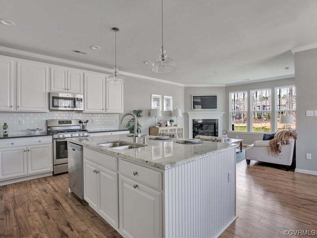 12824 Deep Wl Road Midlothian, VA 23112 - Photo 5 of 44 a kitchen with kitchen island granite countertop a sink cabinets and wooden floor