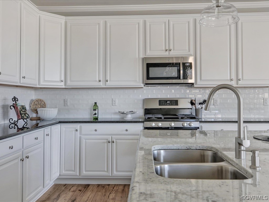 12824 Deep Wl Road Midlothian, VA 23112 - Photo 6 of 44 a kitchen with white cabinets and sink