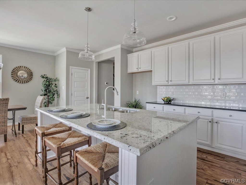 12824 Deep Wl Road Midlothian, VA 23112 - Photo 9 of 44 a kitchen with a table chairs and white cabinets