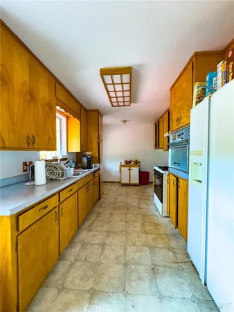 a bathroom with a granite countertop sink a toilet and a shower