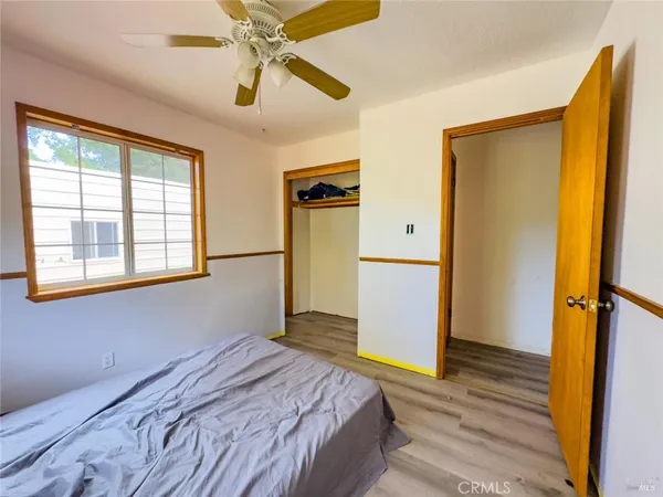 a view of a tennis court with lots of trees in the background