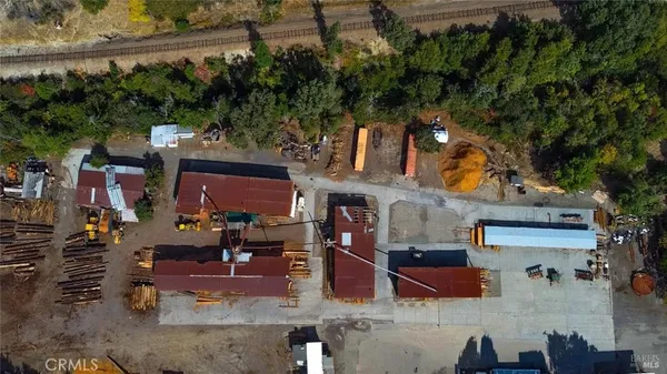 a view of a lake with a table and chairs