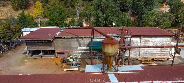 a view of a patio with table and chairs a barbeque grill and a small yard