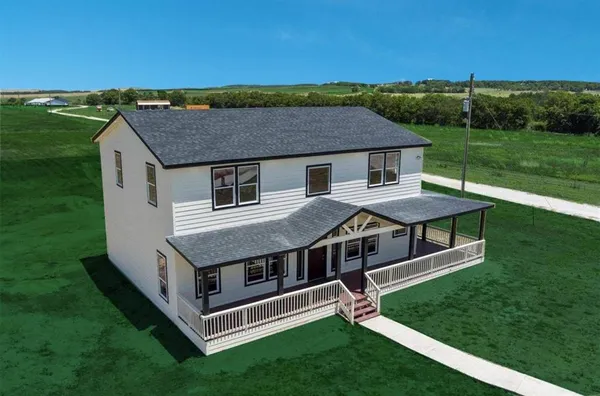 a aerial view of a house with a yard