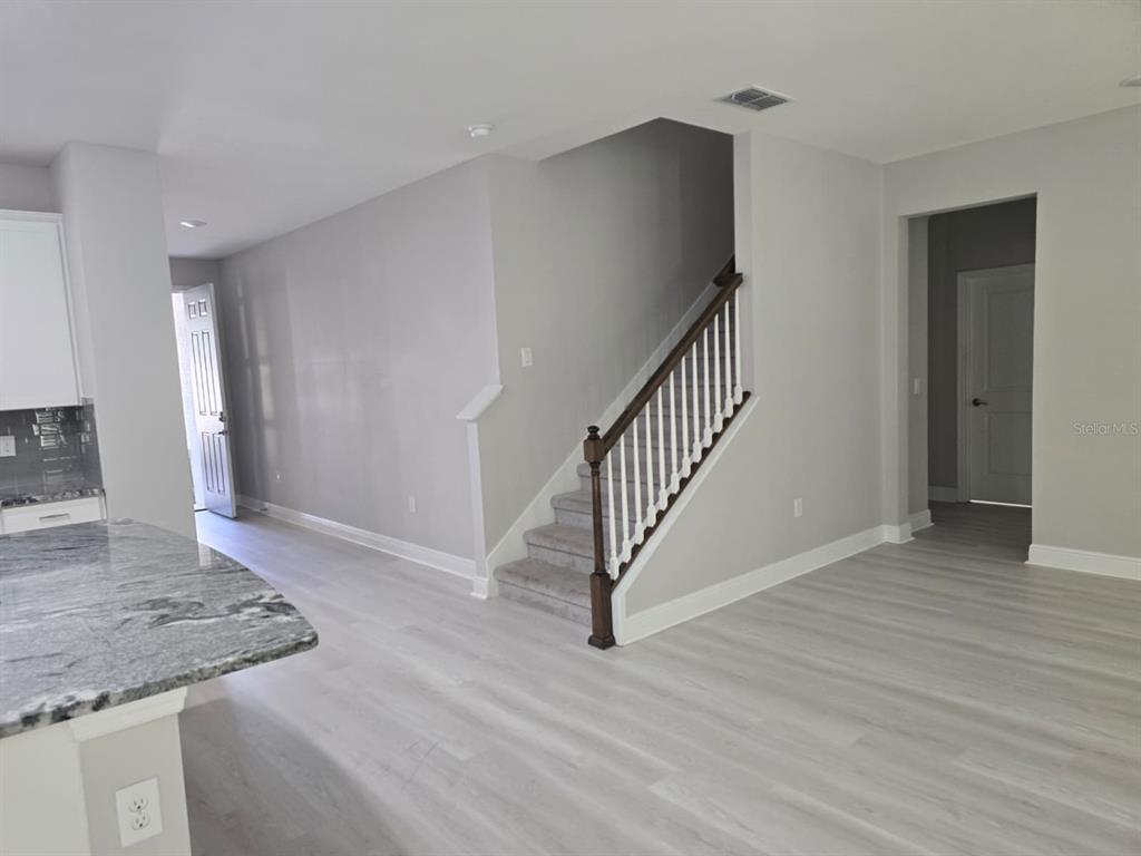 10916 Honor Road Tampa, FL 33625 - Photo 12 of 36 a view of a hallway with wooden floor and staircase