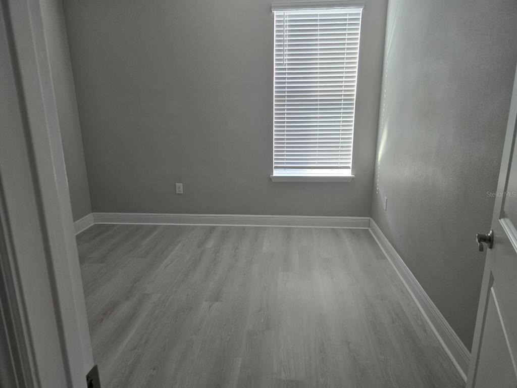 10916 Honor Road Tampa, FL 33625 - Photo 13 of 36 a view of a room with wooden floor and a window