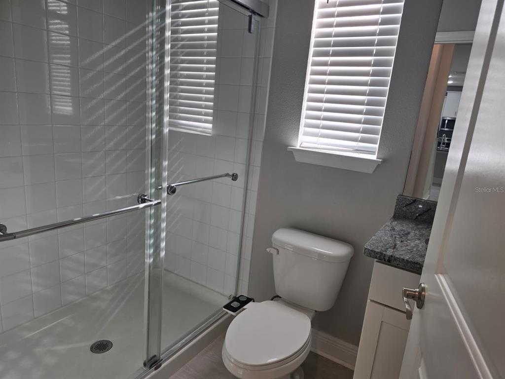 10916 Honor Road Tampa, FL 33625 - Photo 15 of 36 a white toilet sitting next to a bath tub shower