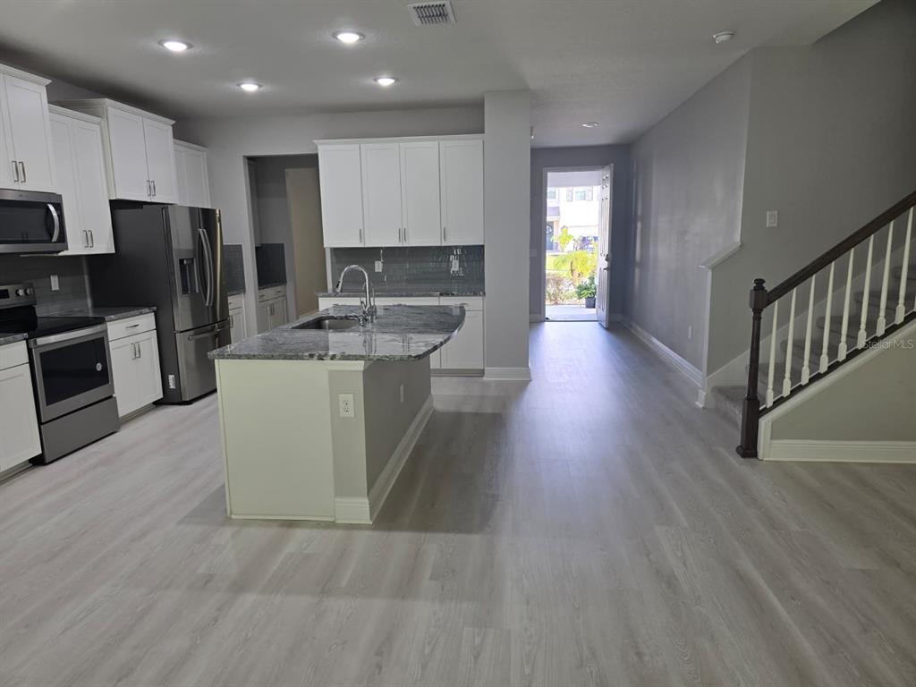 10916 Honor Road Tampa, FL 33625 - Photo 17 of 36 a kitchen with refrigerator and cabinets