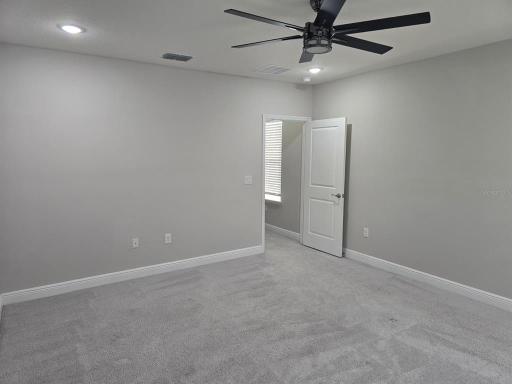 10916 Honor Road Tampa, FL 33625 - Photo 20 of 36 an empty room with windows and fan