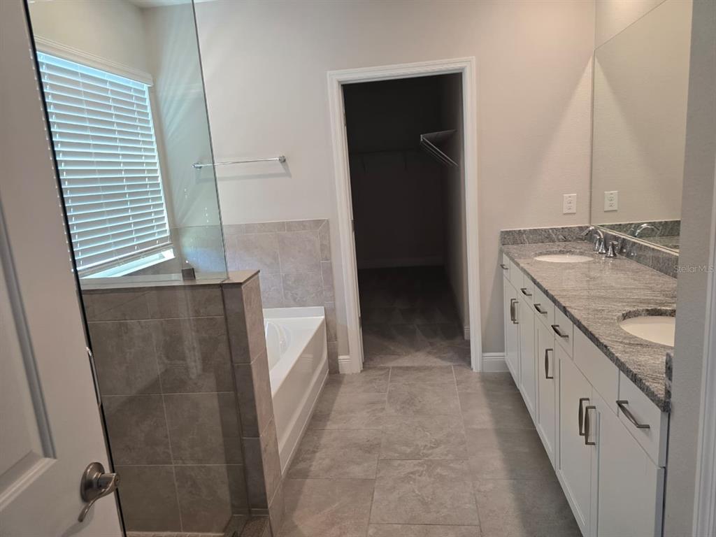 10916 Honor Road Tampa, FL 33625 - Photo 22 of 36 a bathroom with a granite countertop sink and a mirror