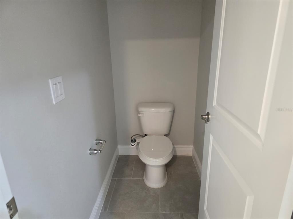 10916 Honor Road Tampa, FL 33625 - Photo 23 of 36 a white toilet sitting next to a white cabinet