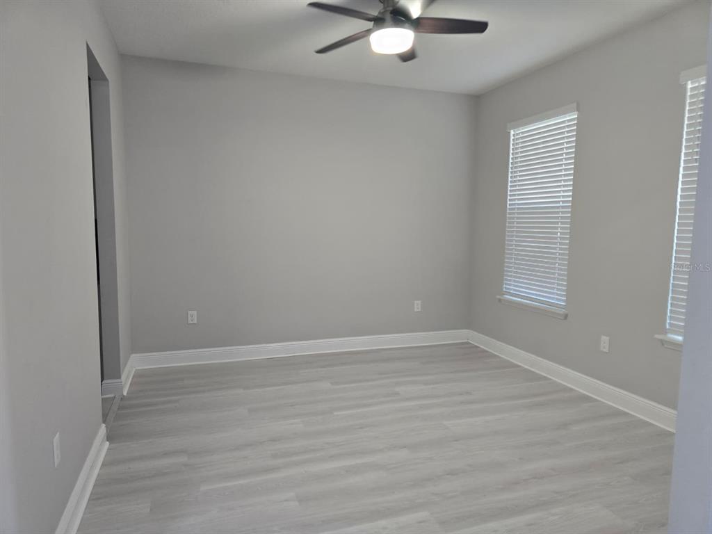 10916 Honor Road Tampa, FL 33625 - Photo 6 of 36 wooden floor in an empty room with a window
