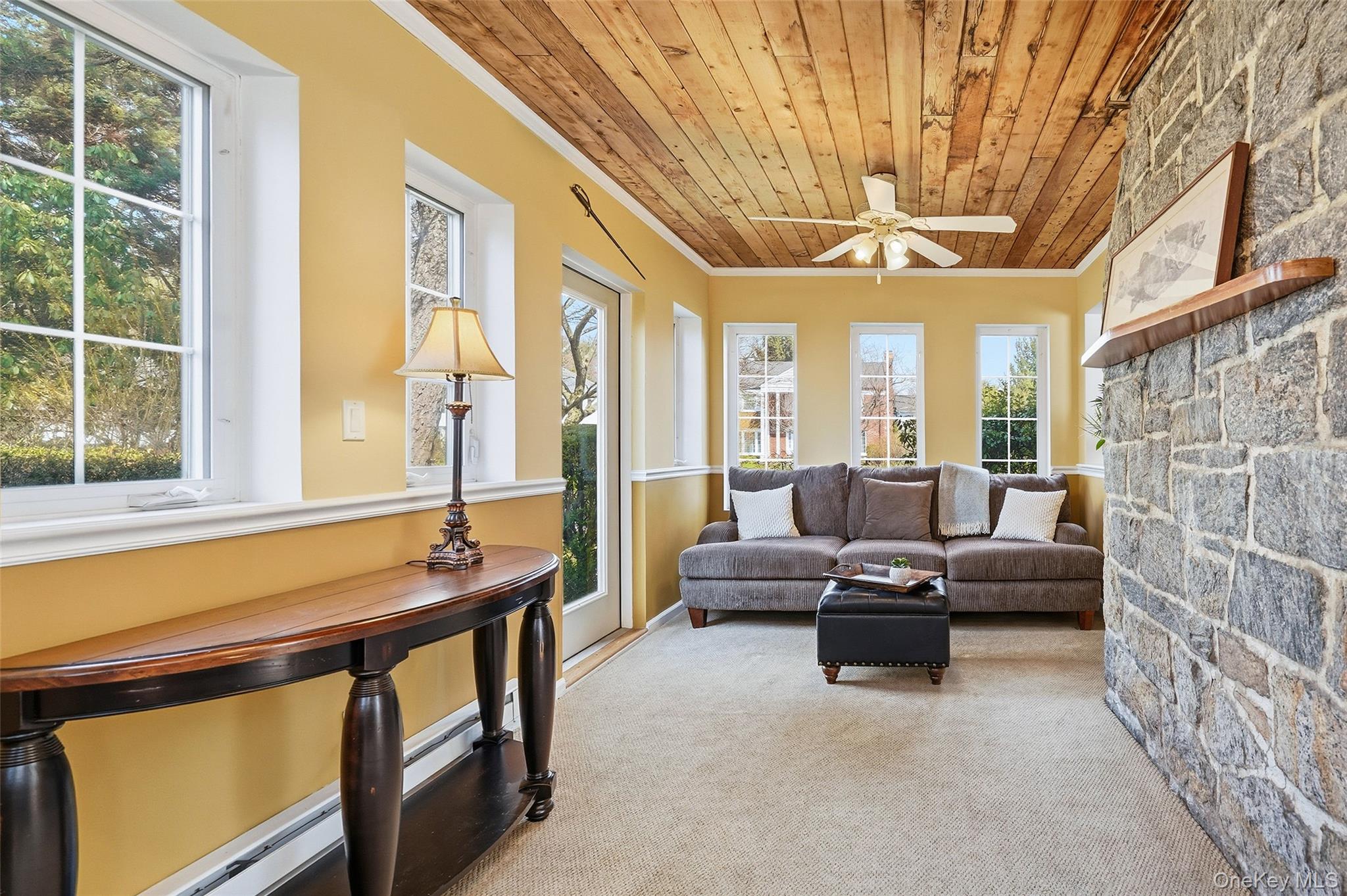 42 Sargent Road Scarsdale, NY 10583 - Photo 12 of 27 The enclosed sunroom/den with light carpet, wooden ceiling, and ceiling fan.