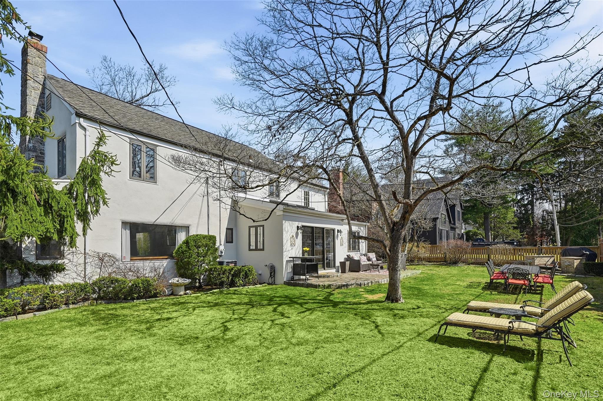 42 Sargent Road Scarsdale, NY 10583 - Photo 24 of 27 Expansive, sun-drenched backyard with a level lawn and inviting patio-your own private setting for entertaining and relaxing.