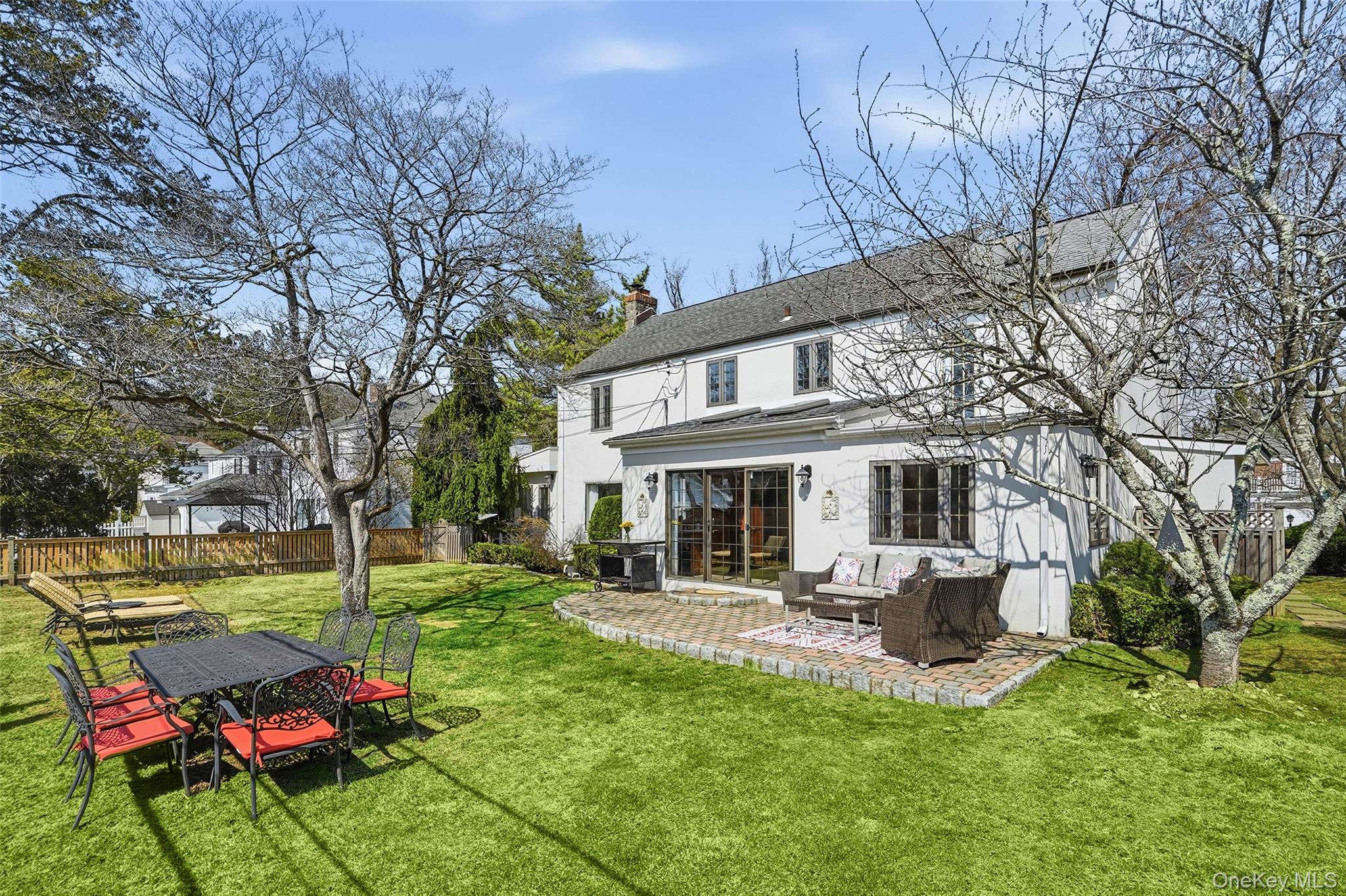 42 Sargent Road Scarsdale, NY 10583 - Photo 27 of 27 Expansive, sun-drenched backyard with a level lawn and inviting patio-your own private setting for entertaining and relaxing.
