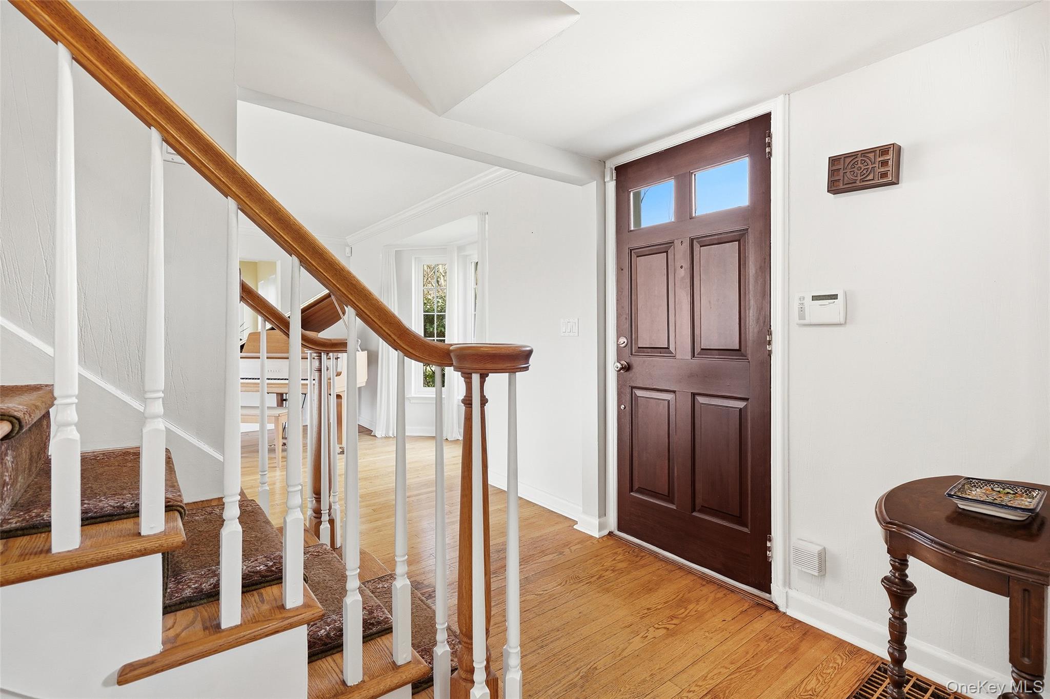 42 Sargent Road Scarsdale, NY 10583 - Photo 3 of 27 Foyer entry way, featuring stairway and hardwood flooring.