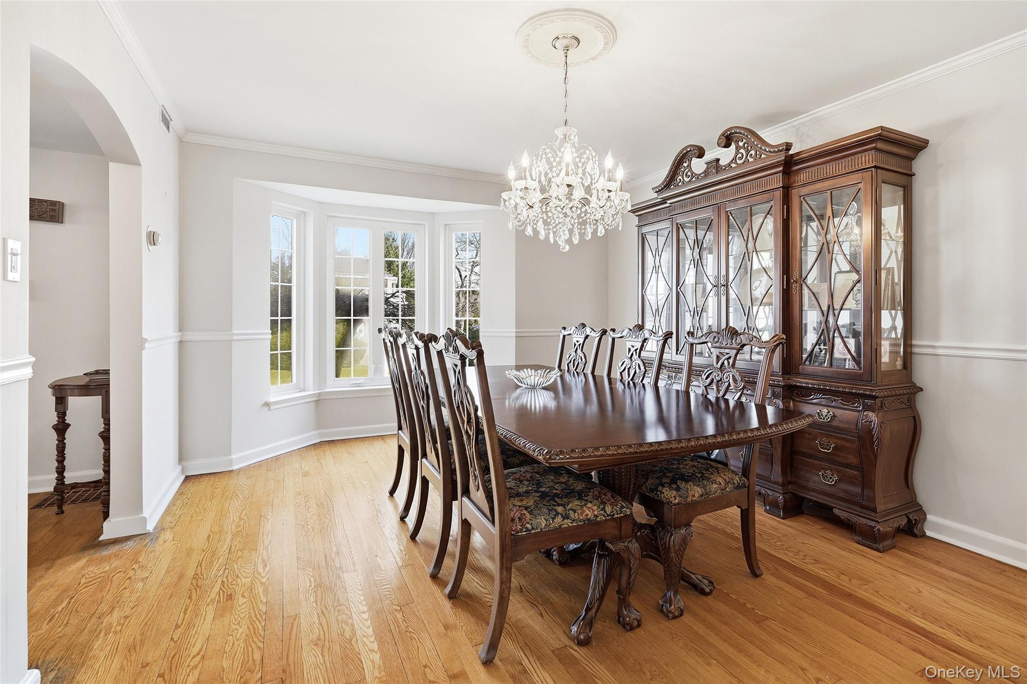 42 Sargent Road Scarsdale, NY 10583 - Photo 6 of 27 Large dining area with hardwood floors, crown molding, and a chandelier - for hosting and everyday dining.