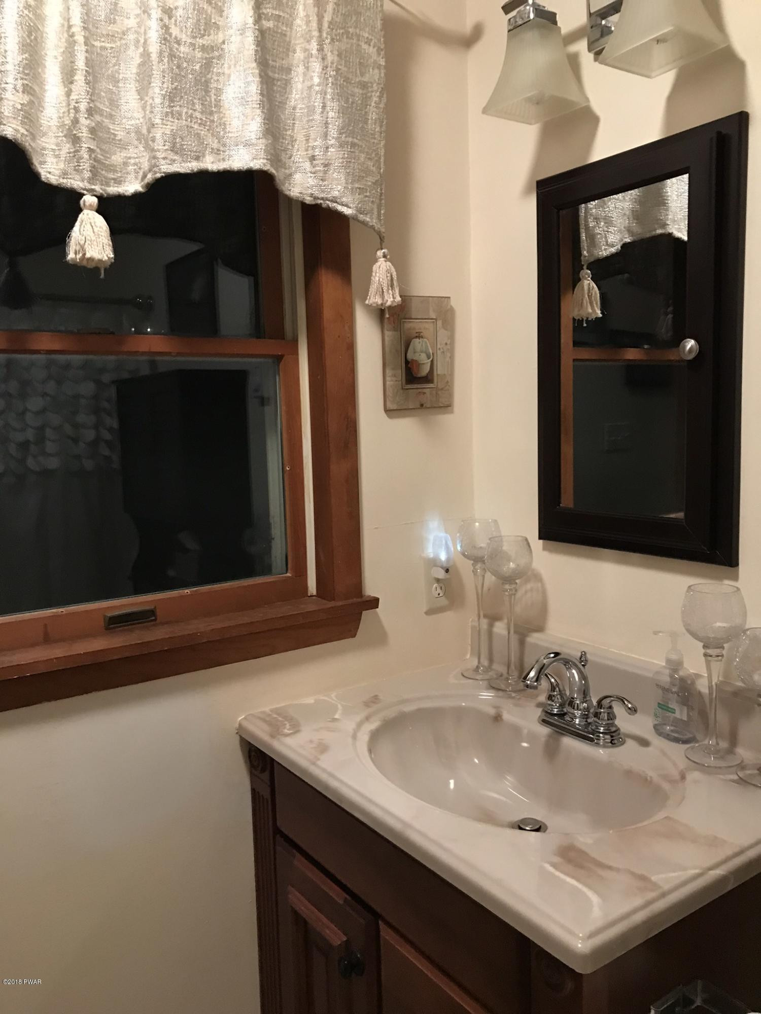186 Gold Key Road Milford, PA 18337 - Photo 16 of 26 a bathroom with a sink and a mirror