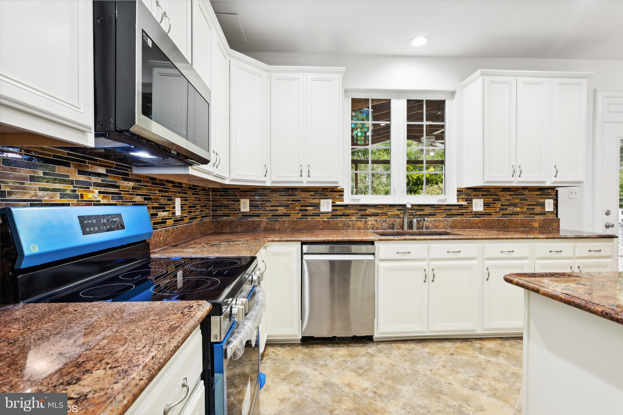 818 Hoods Mill Road Cooksville, MD 21723 - Photo 31 of 108 a kitchen with stainless steel appliances granite countertop a stove a sink and a microwave