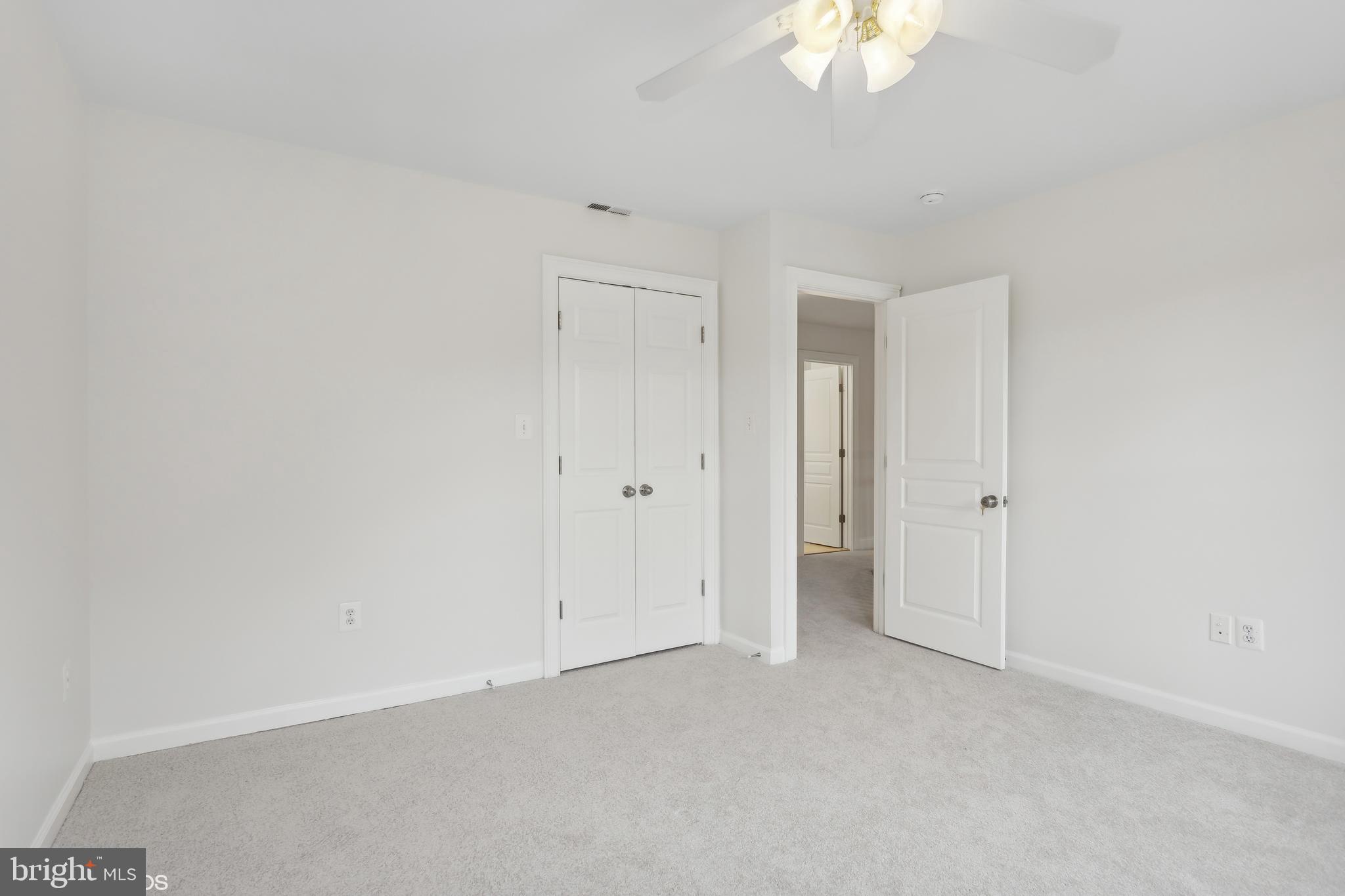 818 Hoods Mill Road Cooksville, MD 21723 - Photo 52 of 108 an empty room with a window and a chandelier fan