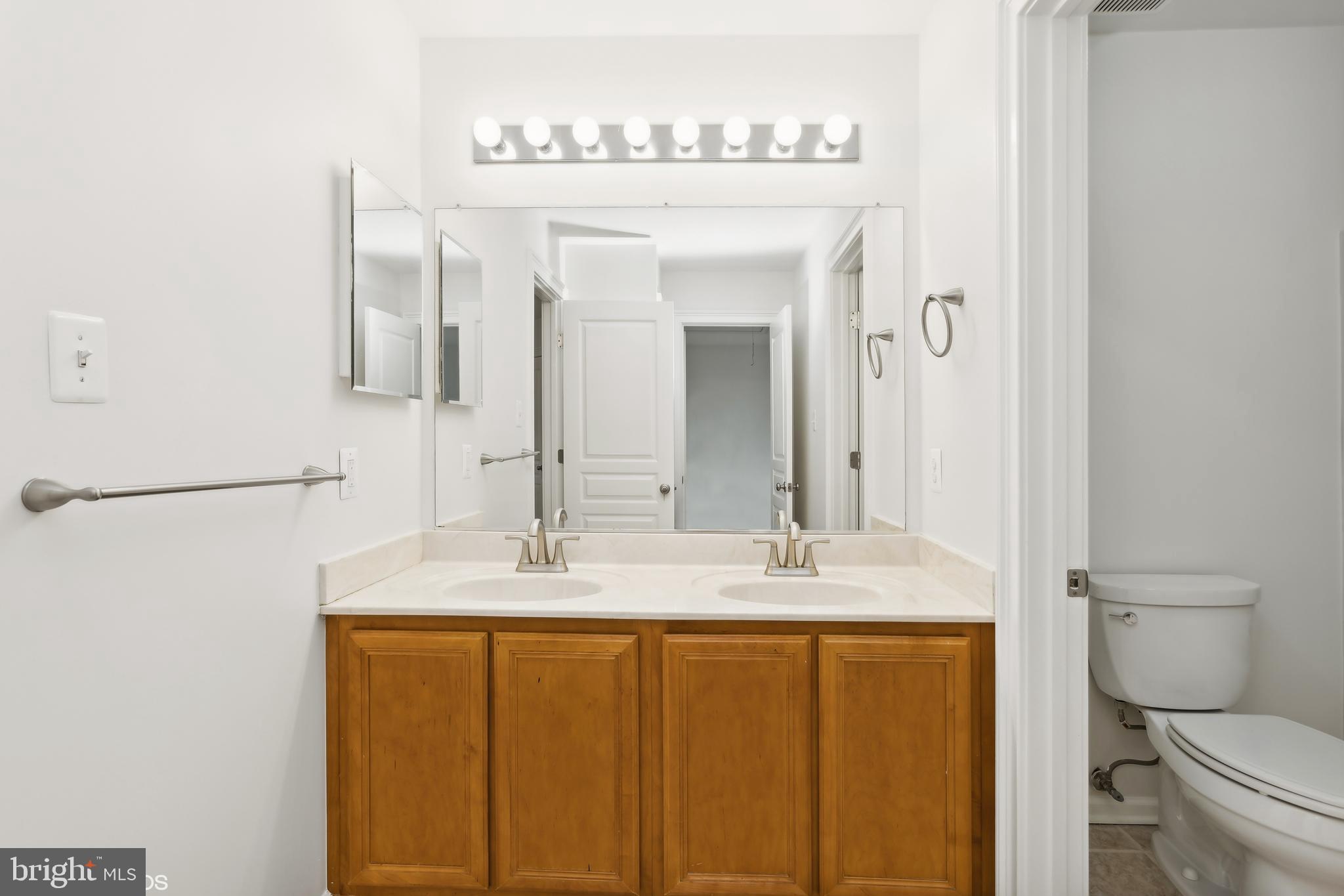 818 Hoods Mill Road Cooksville, MD 21723 - Photo 56 of 108 a bathroom with a granite countertop sink mirror vanity and toilet