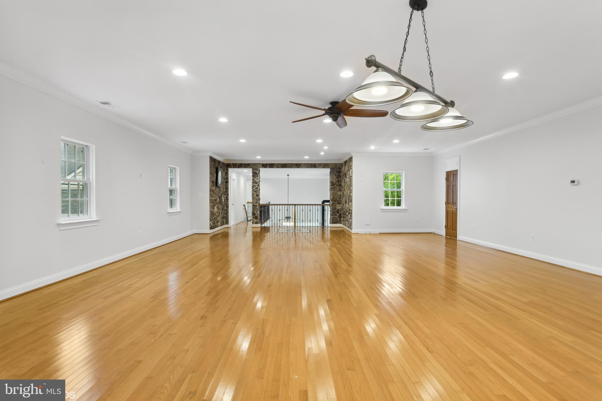818 Hoods Mill Road Cooksville, MD 21723 - Photo 65 of 108 a view of an empty room with wooden floor and a ceiling fan