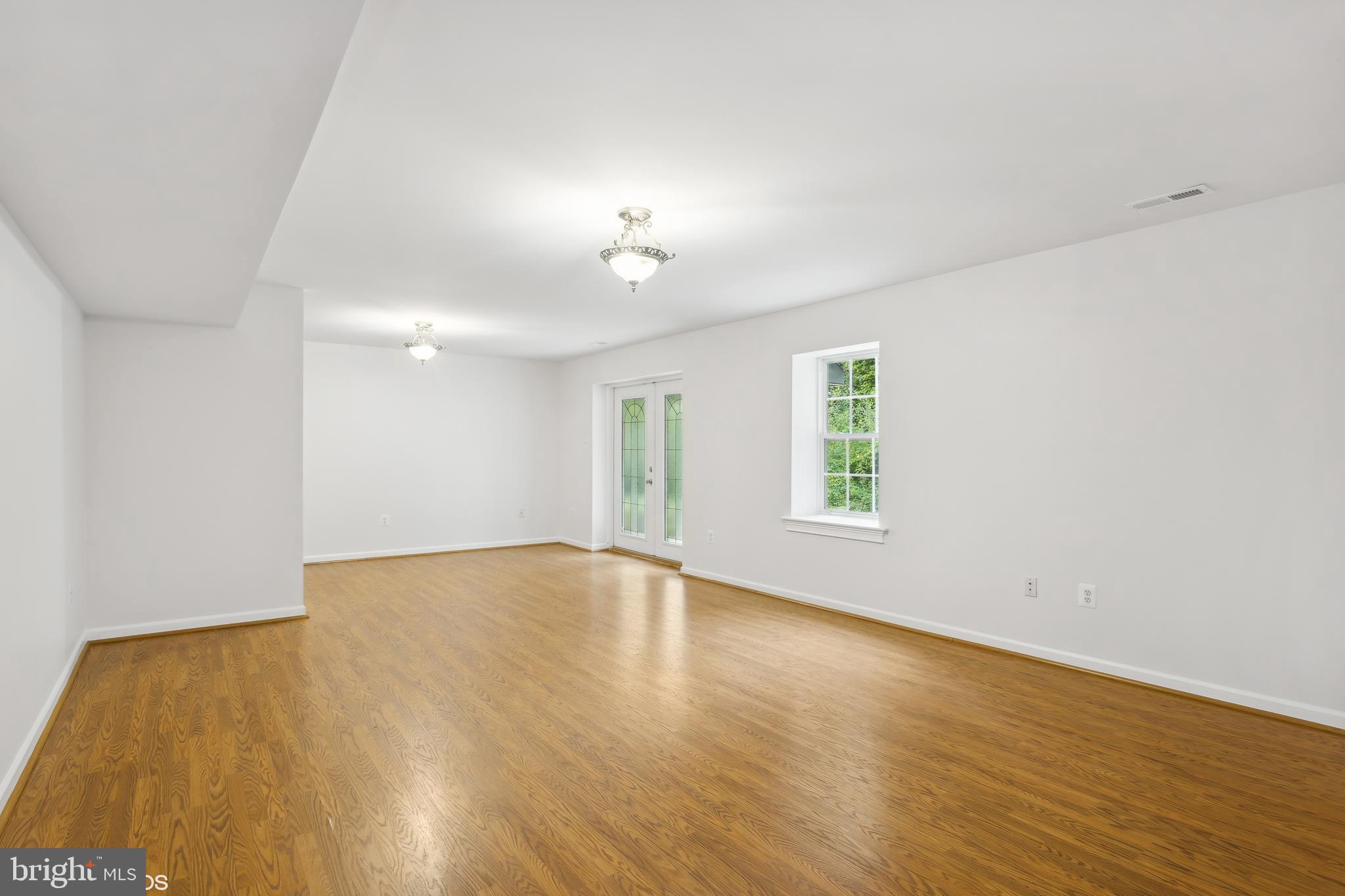 818 Hoods Mill Road Cooksville, MD 21723 - Photo 84 of 108 an empty room with wooden floor and windows