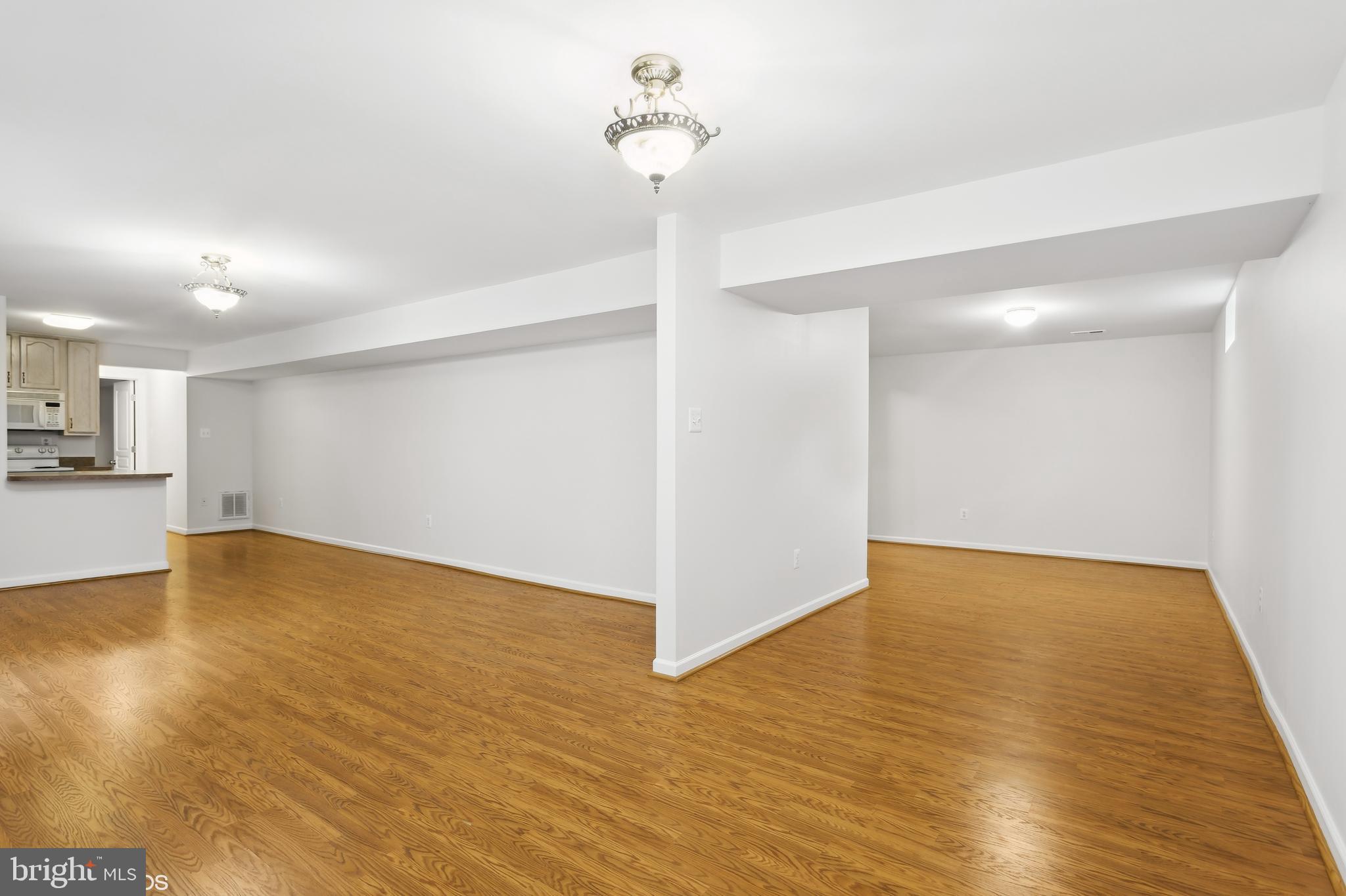 818 Hoods Mill Road Cooksville, MD 21723 - Photo 85 of 108 a view of a room with wooden floor and a ceiling fan