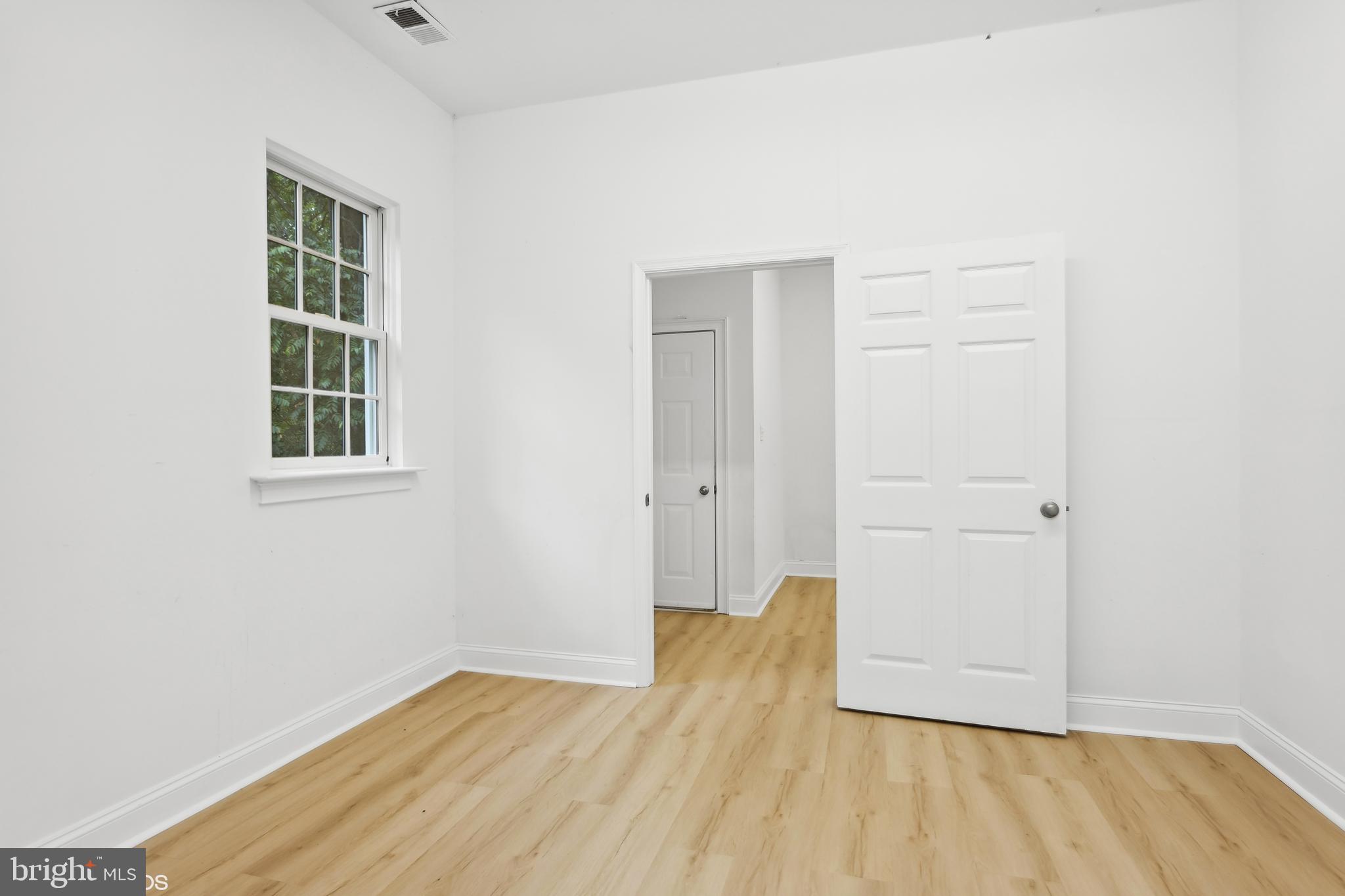 818 Hoods Mill Road Cooksville, MD 21723 - Photo 96 of 108 an empty room with wooden floor and windows